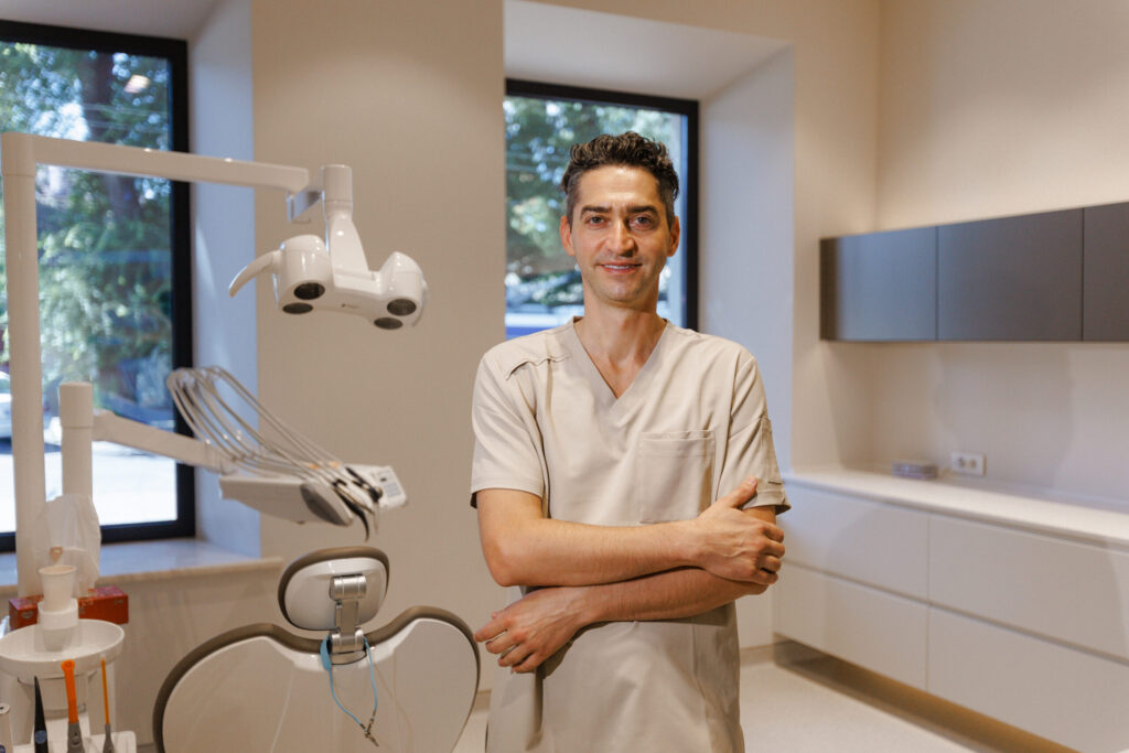 Dr. Rickin Vibhakar smiling in dental office hallway